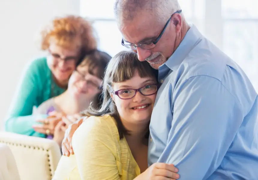 Parents hugging their disabled children needing a special needs trust